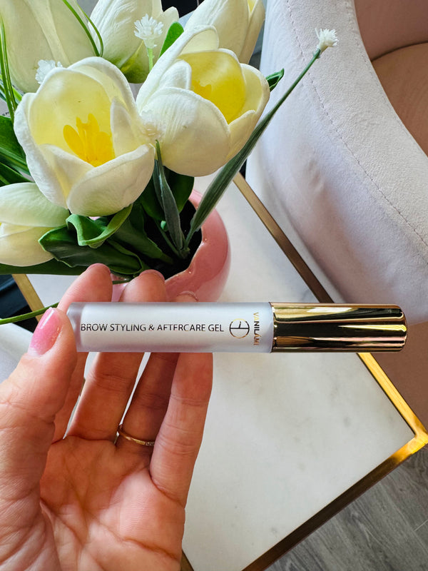 Hand holding a tube of Brow Daddy Brow Styling & Aftercare Gel